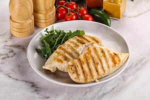 Grilled chicken breast served arugula photo