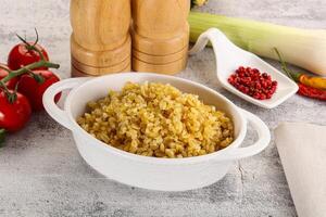 Boiled bulgur wheat in the bowl photo