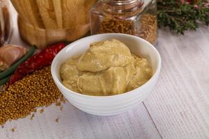 Dijon mustard sauce in the bowl photo