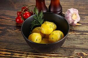 Boiled potato with oil and dill photo