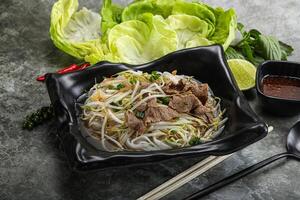 Vietnamese traditional soup Pho Bo with beef photo