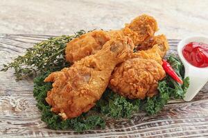 Fried chicken drumsticks with tomato sauce photo