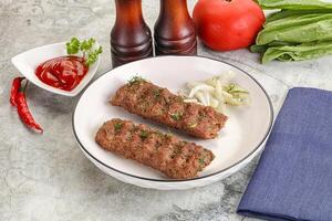 Kebab with beef served onion photo