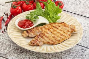 Grilled pork steak with ketchup photo