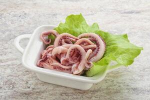Marinated squid tentacles in the bowl photo