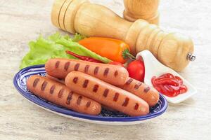 Grilled sausages with tomato sauce photo