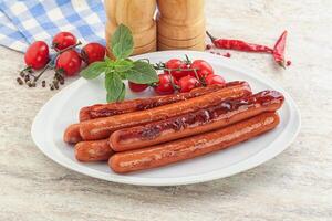 Roasted sausages in the plate photo