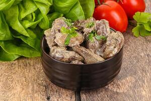 Chicken liver with cream sauce photo