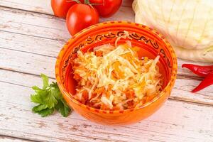 Fermented cabbage sauerkraut in the bowl photo