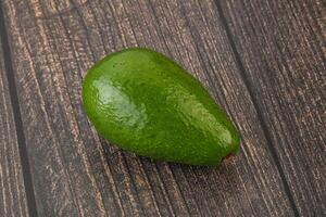Ripe green avocado over background photo