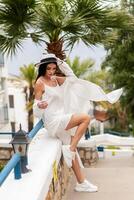 A beautiful tourist wearing straw hat standing photo