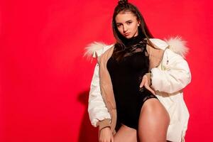 girl white jacket poses red background photo
