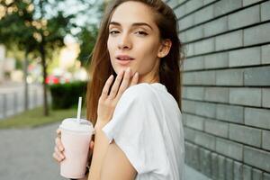 Portrait of a young brunette woman in a white T-shirt photo