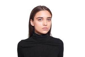 Confident female wearing black turtleneck sweater while posing photo