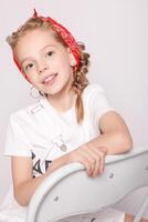 Light brown hair beautiful little girl in white t-shirt photo