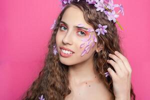 Beautiful girl with flowers in in hair photo