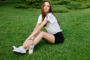 Portrait of a young brunette woman in a white T-shirt photo