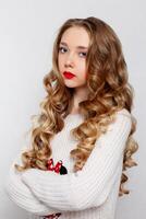 Beautiful model brunette with long curled hair photo