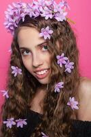 Beautiful girl with flowers in in hair photo