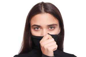 Confident female wearing black turtleneck sweater while posing photo