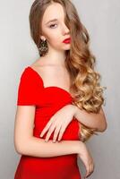 Beautiful model brunette with long curled hair photo