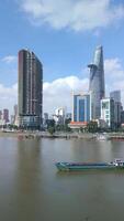 Cargo ship on the Saigon River and Ho Chi Minh City skyline, Vietnam video