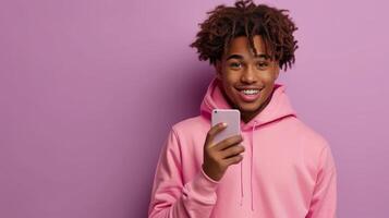 ai generado utilizando móvil digital aplicaciones en Teléfono móvil mensajes de texto en teléfono inteligente, esta Rizado africano americano adolescente chico modelo usa un rosado capucha y sostiene un célula teléfono. aislado en un ligero púrpura antecedentes foto