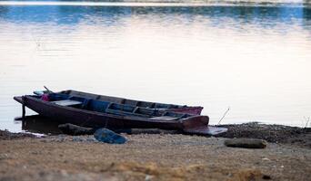 Old Fishing Boat Drifting on River photo