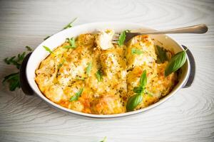 baked cauliflower with vegetables and cheese and scrambled eggs photo