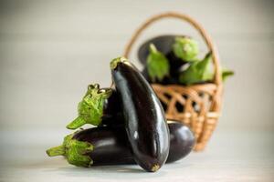 ripe purple eggplant on a wooden background photo