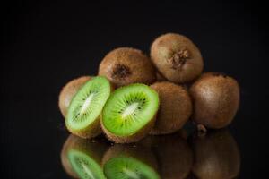 Kiwi fruit slice closeup on black background photo