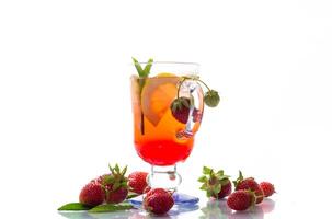 refreshing cool strawberry lemonade with lemon, ice and mint in a glass photo