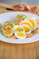 boiled eggs with boiled shrimp in a plate for breakfast photo