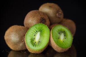 Kiwi fruit slice closeup on black background photo