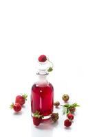 sweet cooked strawberry syrup in a glass decanter photo