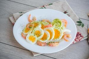 boiled eggs with boiled shrimp in a plate for breakfast photo