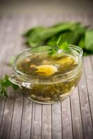 Spring soup from fresh sorrel with boiled eggs in a plate photo