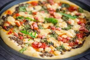 cooked pizza with mushrooms and vegetables with cheese and spices photo