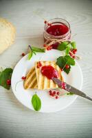 fried bread croutons for breakfast with redcurrant jam in a plate with berries photo