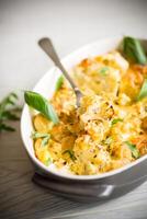 baked cauliflower with vegetables and cheese and scrambled eggs photo