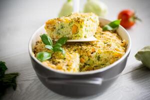 vegetable casserole of patissons, zucchini, carrots in a ceramic form . photo