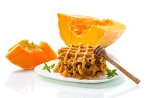 sweet baked pumpkin waffles with honey in a plate photo