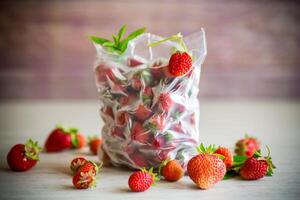 frozen fresh strawberries in a vacuum bag photo