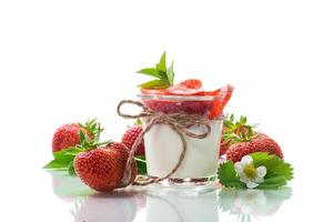 sweet homemade yogurt with strawberry jam and fresh strawberries in a glass cup photo