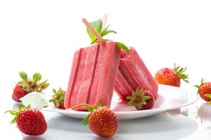 homemade strawberry ice cream on a stick made from fresh strawberries in a plate photo