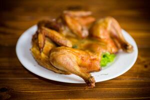 whole fried chicken in a plate on table photo