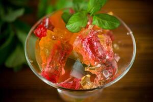 colored sweet fruit jelly in a glass glass photo