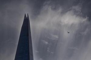London, London, United Kingdom, 2023 - The Shard and Plane photo