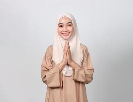 AI generated asian muslim lady wearing muslim dress and hijab put her hand together photo