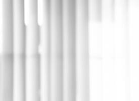Blurry Light and shadows lines from curtain on the white wall. Sunny day with sun rays reflection from window. Element design for Mockup, Copy space for text photo